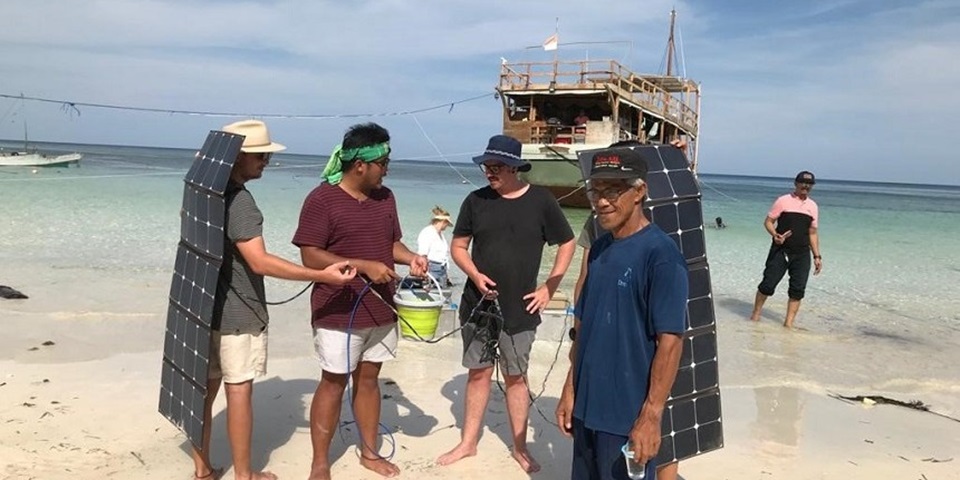 Murdoch University students demonstrate solar powered water kits to residents of islands off Massakar, Indonesia