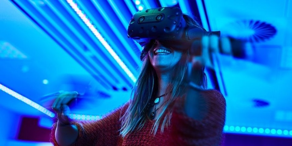 Technology feature image 860 x 480 px A student smiles while trying a virtual reality headset