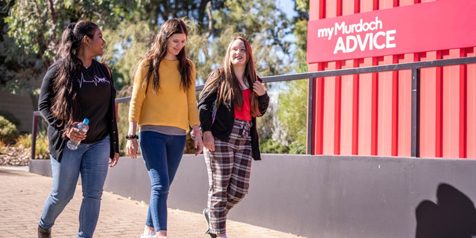 Three students walking near an advice hub Feature Three students walking near an advice hub