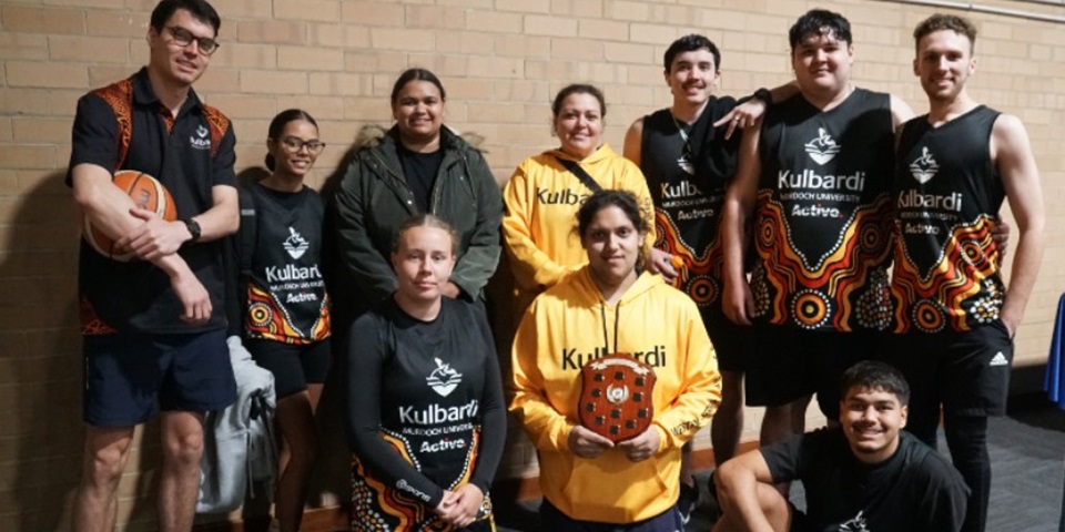 Kulbardi team together holding the state UniSport competition shield