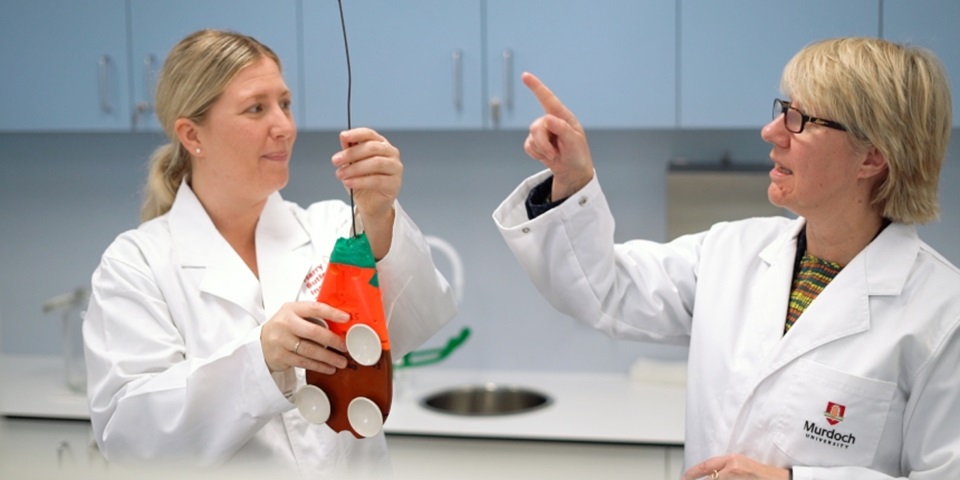 Vice Chancellor Eeva Leinonen in lab coat with scientist