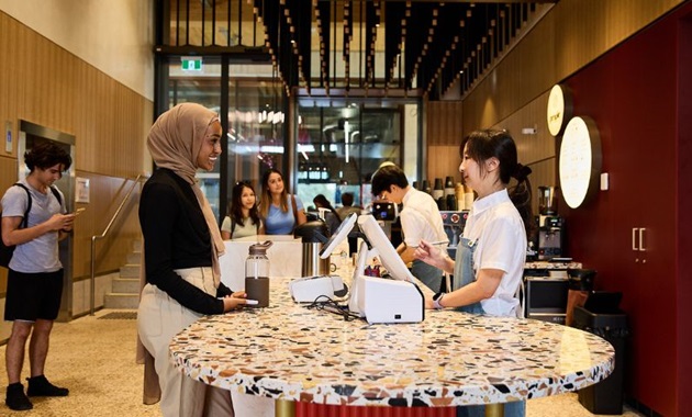 Murdoch student ordering coffee at Boola Katitjin