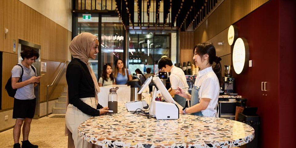 Murdoch student ordering coffee at Boola Katitjin