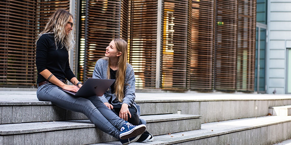 Woman and daughter sitting on stairs feature Woman and daughter sitting on stairs
