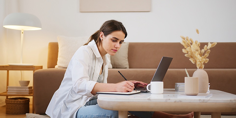 Woman writing at study desk feature Woman writing at study desk