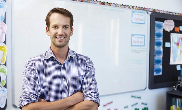 Male teacher in front of white board