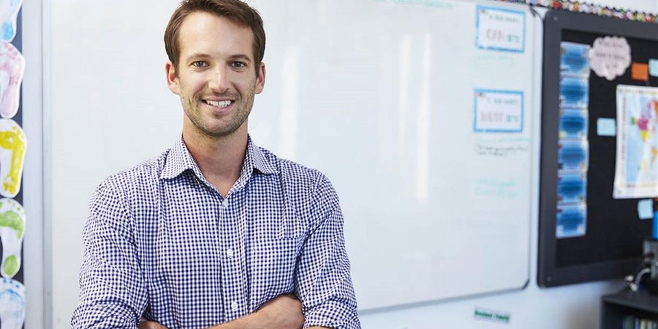 Male teacher in front of white board