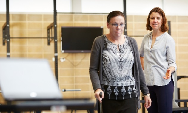 Dr Yvonne Learmonth guiding a patient through physiotherapy