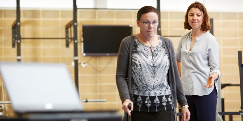 Dr Yvonne Learmonth guiding a patient through physiotherapy